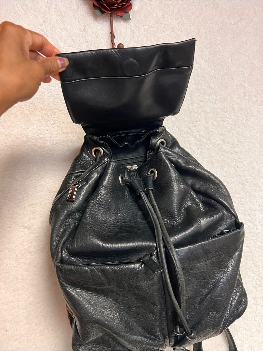 Perlina Black Leather Drawstring Flap Backpack
